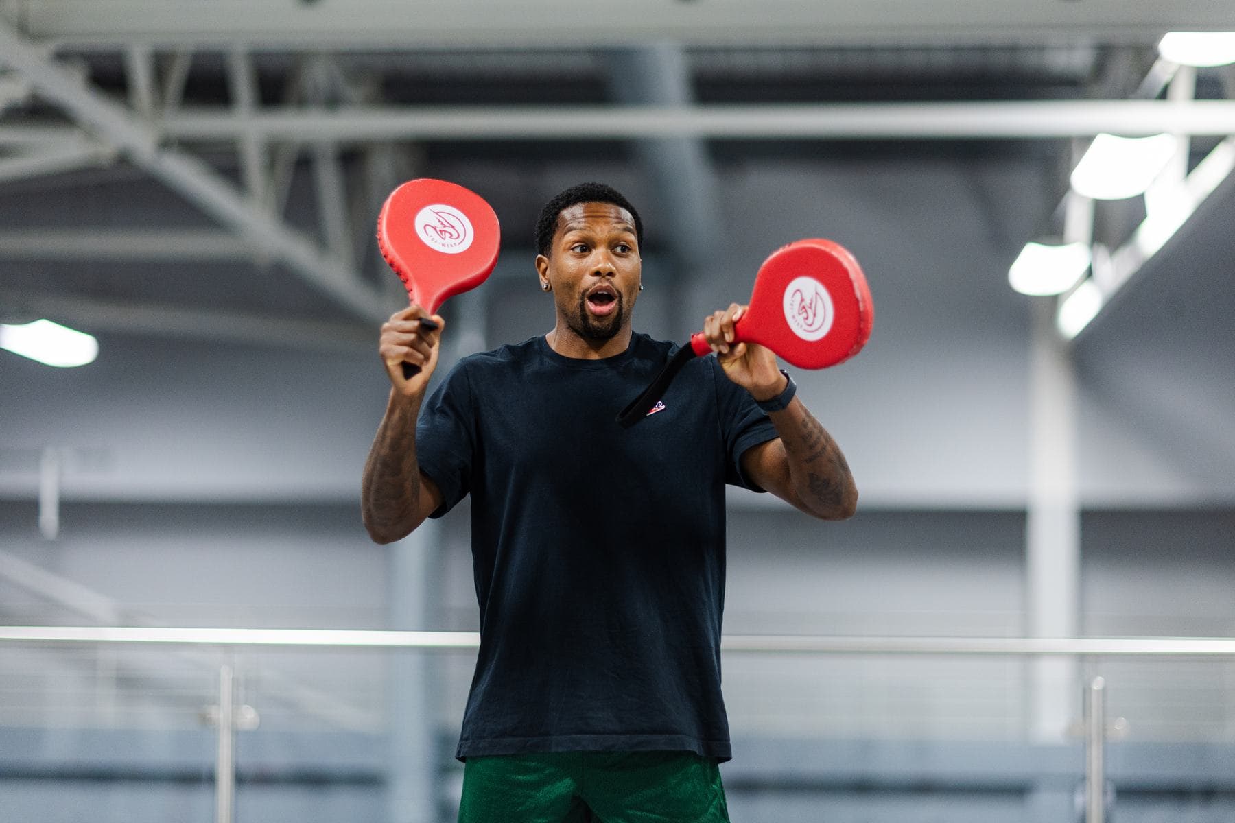 Naphtali Nembhard holding red coaching pads