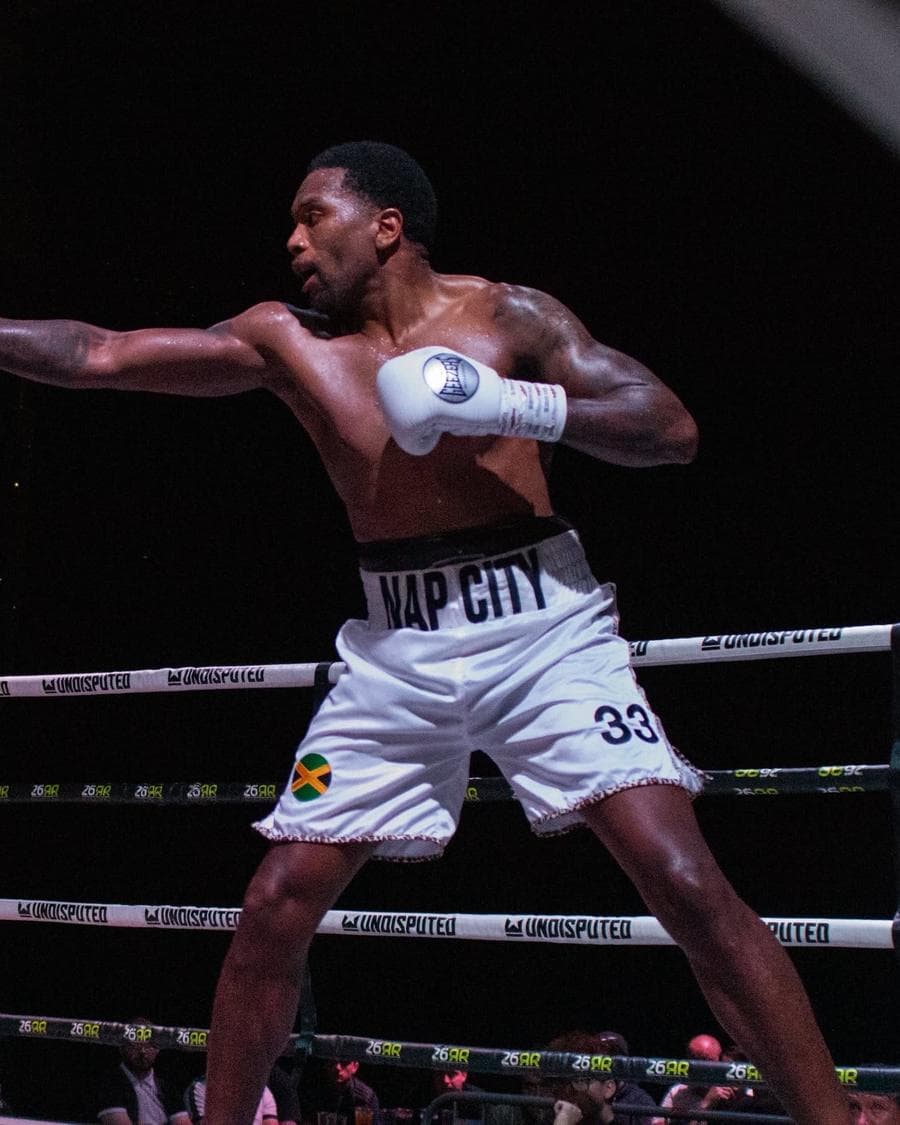 Naphtali Nembhard throwing a punch during a professional boxing bout